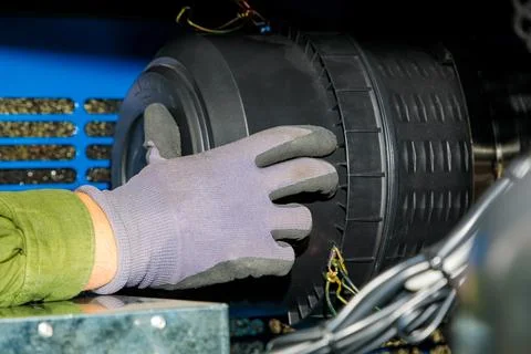 Technician installing or replacing air filter in industrial equipment Stock Photos