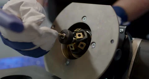 Technician installing a professional cutter head into a CNC machine Video stock 329479319