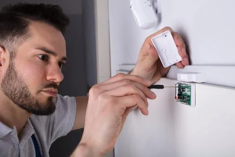 Technician Installing Security System Door Sensor Foto stock