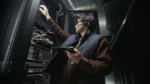 Technician Installing Server Hardware Using Tablet and Headset Stock-Footage 330539198