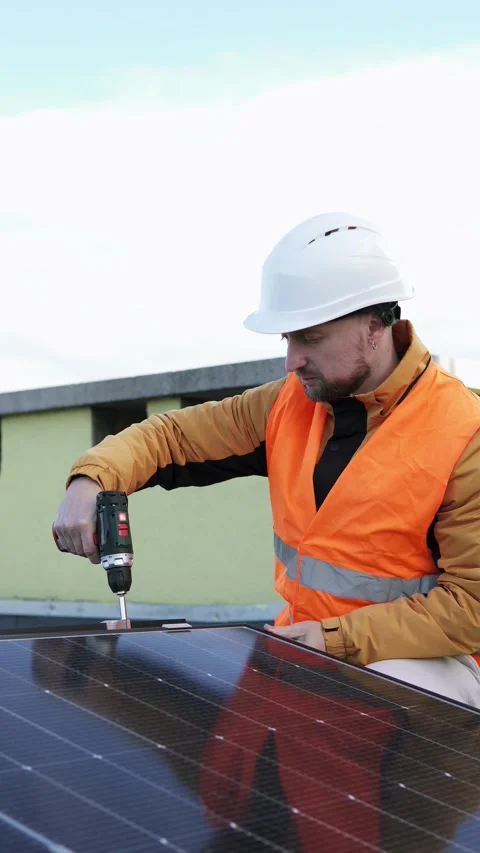 Technician installing solar panels on rooftop. Concept of renewable energy. Stock Footage 320547115