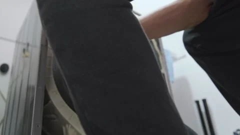 Technician installing washing machine drum pulley wheel Stock Footage 328385330
