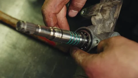 The technician installs the silicone o-ring in steering rack inner part covering Stock Footage 285641328