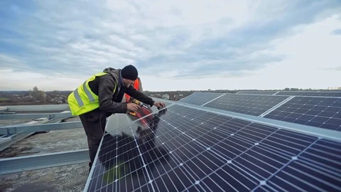 Technician installs solar battery. Workers installing new photovoltaic panels. Stock-Footage 124708281