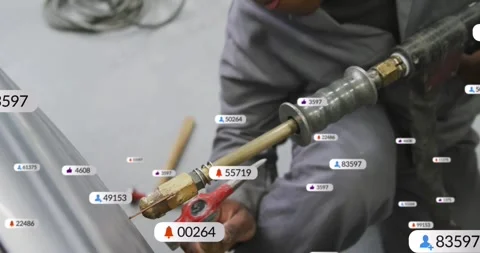 Technician kneeling using blowtorch on metal sheet in factory, with floating Stock Footage 325702810