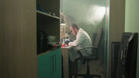 Technician in Lab Coat Working on Electronics Under Microscope Video stock 283122259