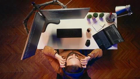 Technician listening music while using coding to fortify firewalls Stock-Fotos