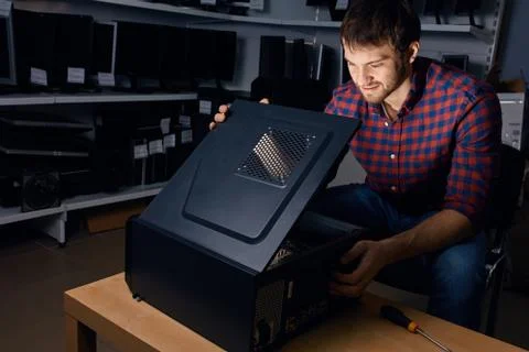 Technician looking at the broken system unit Stock Photos