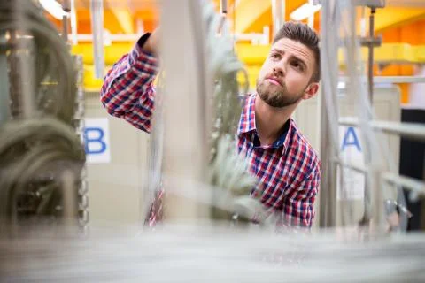 Technician looking at cables of the server Stock Photos