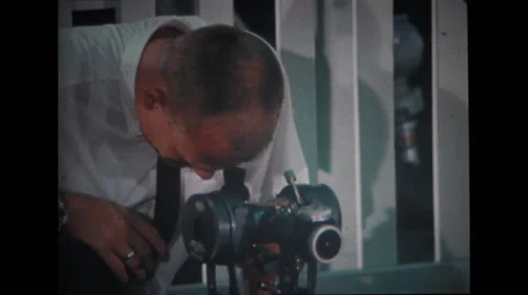 Technician looking through sextant equipment Stock Footage 37596993
