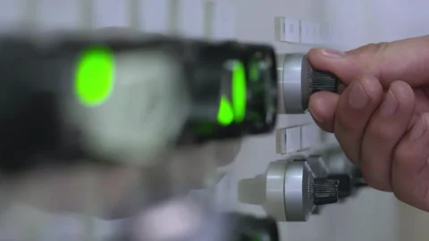 Technician machine operator hand adjusting switches dial on a PLC industrial Stock Footage 348251006