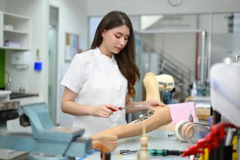 Technician making prototype of prosthetic leg, Artificial metal limb Stock-Fotos