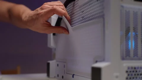 Technician male installing protective mesh on side cover of computer system unit Stock Footage 268899081