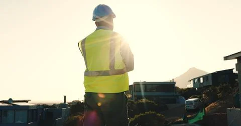 Technician, man and thinking at construction site with suburb view, decision or 写真素材