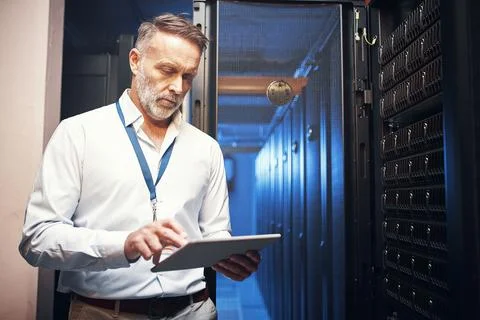 Technician, man and typing on tablet in server room for maintenance, diagno.. Stock Photos