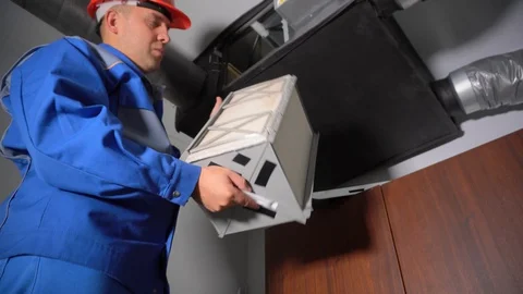 Technician man Install Filter for Central Air Ventilation Recuperation System Stock Footage 127915570