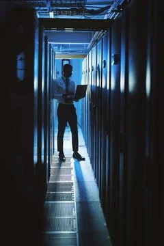 Technician, man or laptop in server room at night for cybersecurity, softwa.. Stock Photos