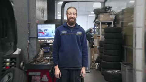 Technician man portrait. Mechanic guy look at camera. Tire service. Car repair. Stock Footage 273287939