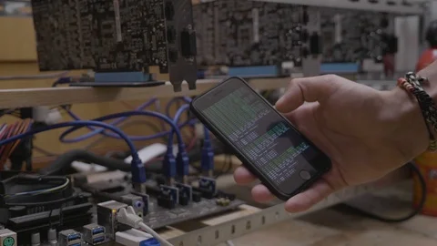Technician man showing mining software progress on smartphone display near th Stock Footage 102472578