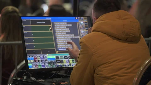Technician managing stage lighting system using advanced computer interface Stock Footage 314011869