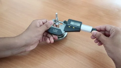 The technician measures dimensions using a micrometer Stock Footage 256477566