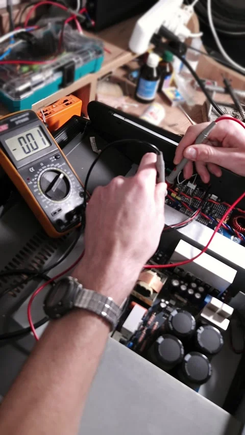 Technician Measuring Electronic Circuit Board Components with Digital Multimeter Stock Footage 339001858