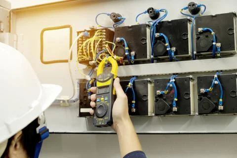 Technician is measuring voltage or current by Clampmeter Stock Photos