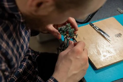 A technician meticulously assembles a circuit board with precision, showcas.. Stock Photos