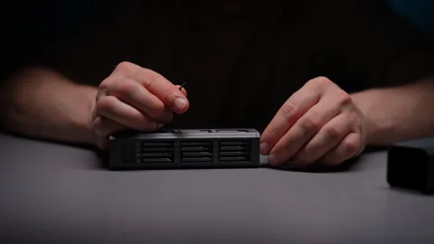 Technician meticulously choosing precision screwdriver bit from neatly arranged Stock Footage 292933258