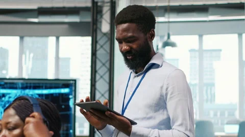 Technician next to office coworkers developing AI software applications Stock Footage 313017132