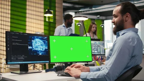 Technician in office using green screen PC, automating repetitive tasks with AI Stock Footage 313016947