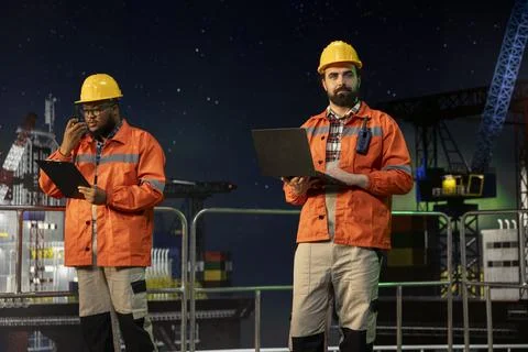 Technician on offshore platform using laptop to control subsea systems Stock Photos