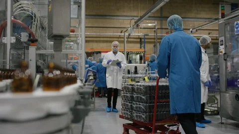 Technician operating control board near production line in cosmetic factory Stock Footage 107981633