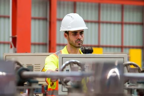 Technician Operating Equipment at Control Panel in Industrial Manufacturing.. Fotos de archivo