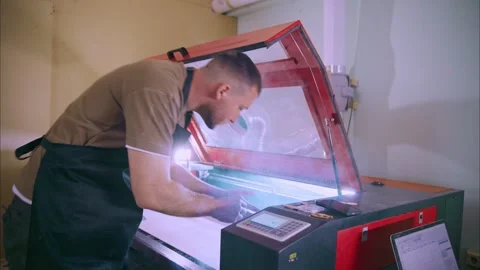 Technician operating laser engraving machine in workshop Stock-Footage 308931907