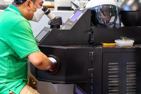 Technician Operating Laser Welding Machine with Stereo Microscope for Jewel.. Stock Photos