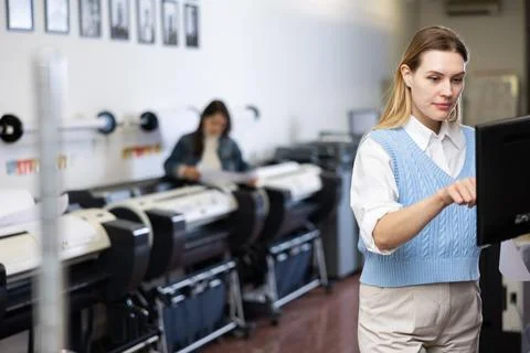 Technician operator calibrating plotter machine, typing on computer keyboard Stock Photos
