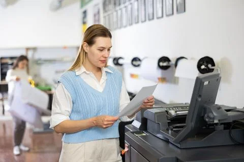 Technician operator calibrating plotter machine, typing on computer keyboard Stock Photos