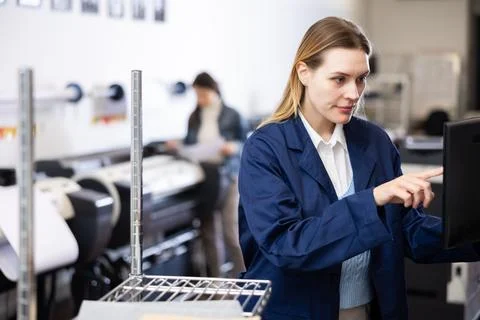 Technician operator calibrating plotter machine, typing on computer keyboard Stock Photos