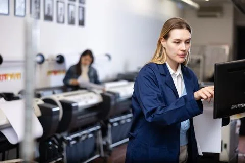 Technician operator calibrating plotter machine, typing on computer keyboard Stock Photos