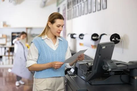 Technician operator calibrating plotter machine, typing on computer keyboard Stock Photos