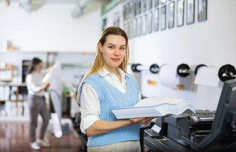 Technician operator changes paper on printer plotter machine Fotos de archivo