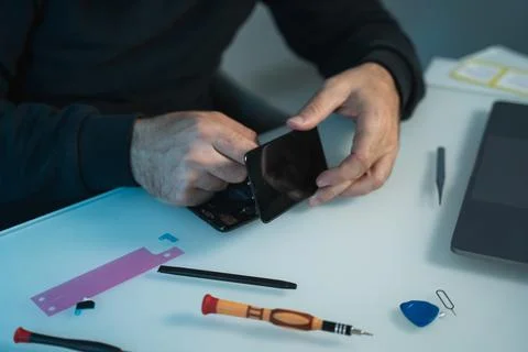 Technician or engineer preparing to repair and replace new smartphone screen 스톡 사진
