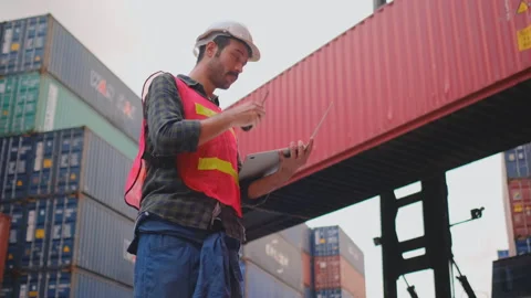 Technician or engineer worker use walkie talkie contact with team then typing Stock Footage 130689166