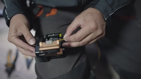 Technician performing precise optical fiber splicing for network cable connec Stock Footage 330695876