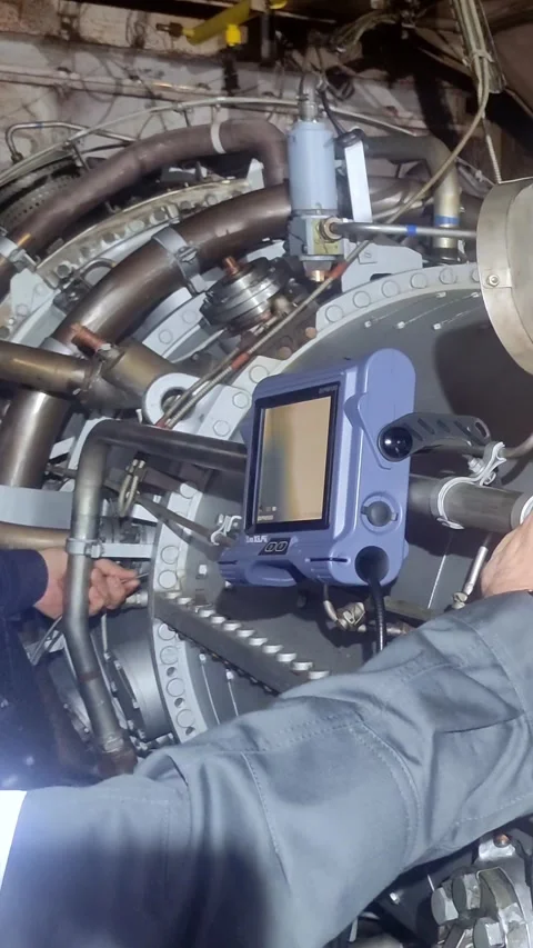 Technician performs detailed endoscopic examination of turbine inner casing Stock Footage 282845450