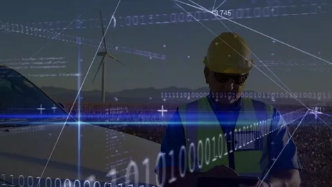 Technician picking up device sending turbine data for monitoring while HUD Stock Footage 332523112