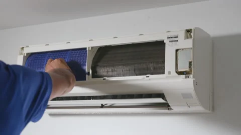 Technician placing back clean filter into air conditioner Video stock 201415539