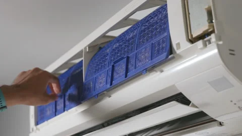 Technician placing back clean filter into air conditioner Video stock 219377452
