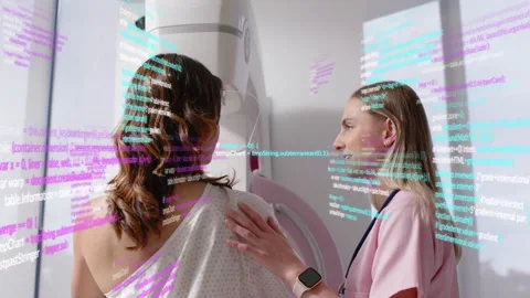 Technician placing hand guiding patient into breast unit, animated code overlay Stock Footage 330284474